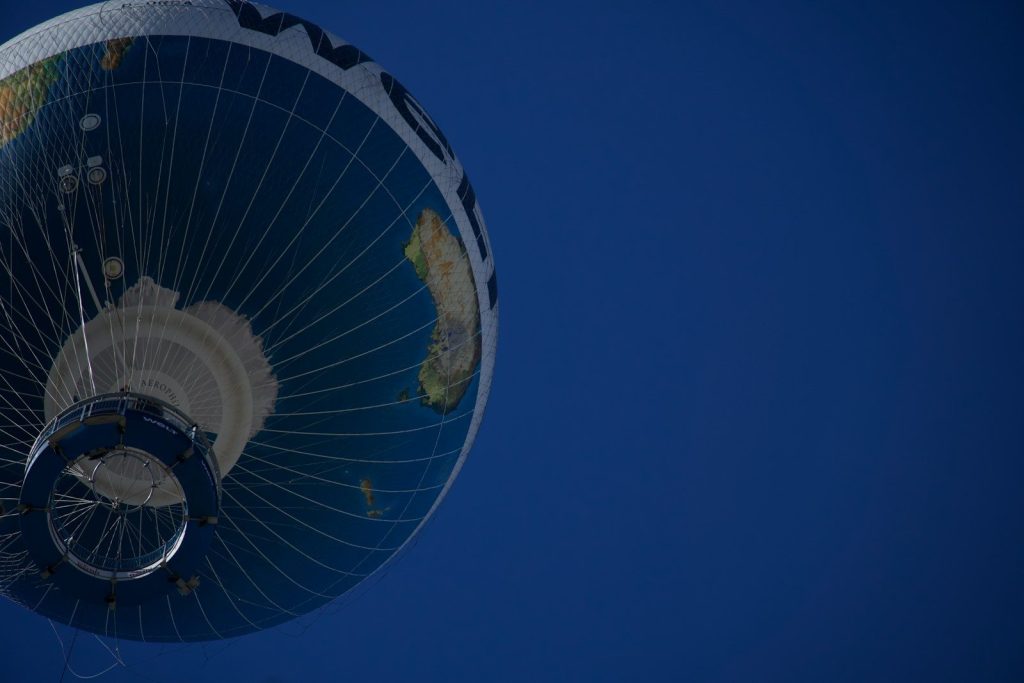 Hot air balloon with earth design against blue sky