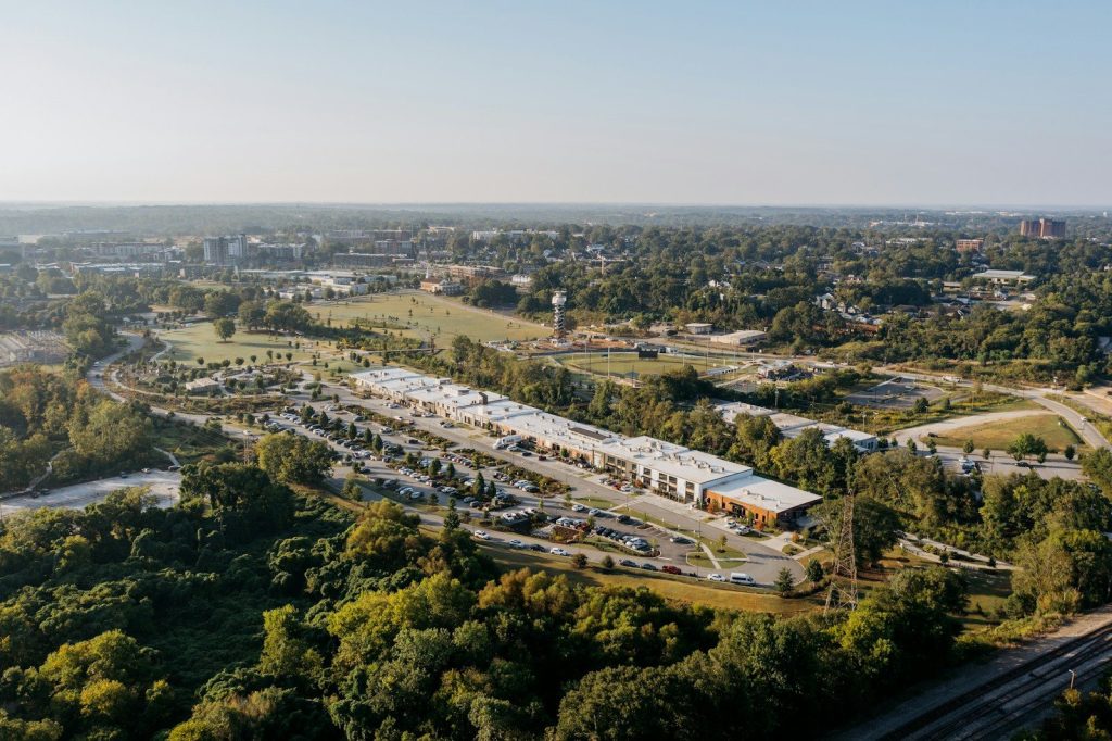 Aerial view of a modern building complex surrounded by trees.