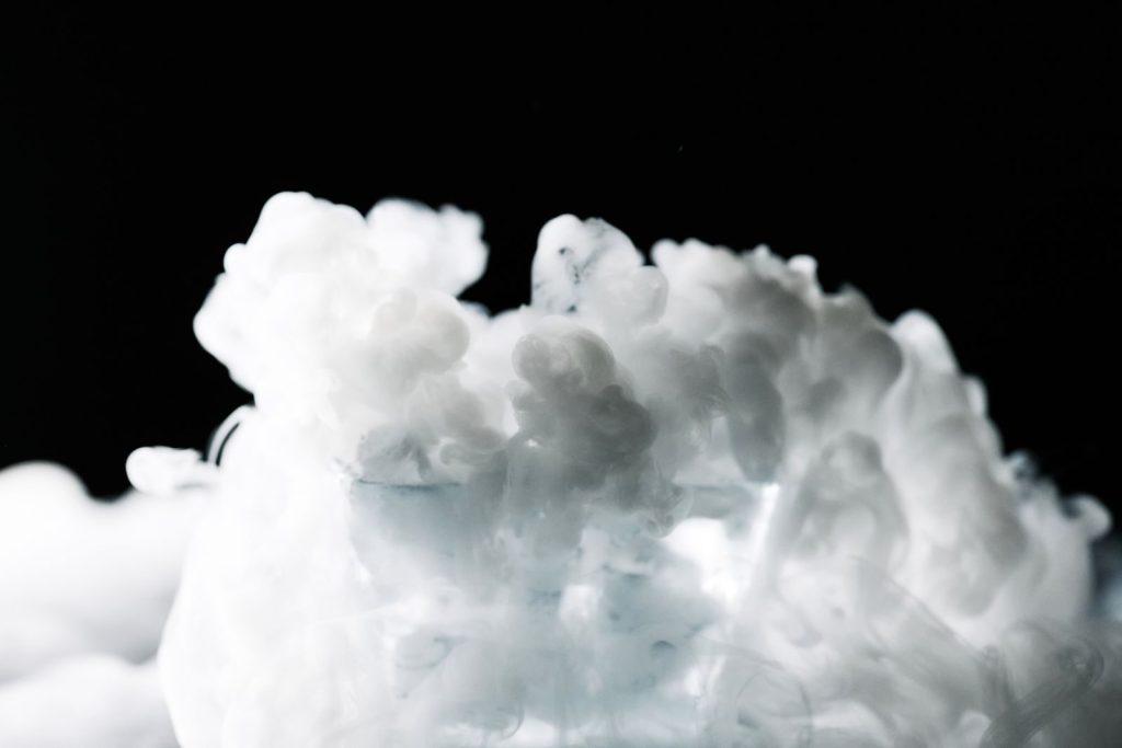 A captivating image of white smoke cloud against a dark background, creating an ethereal and mysterious visual effect.