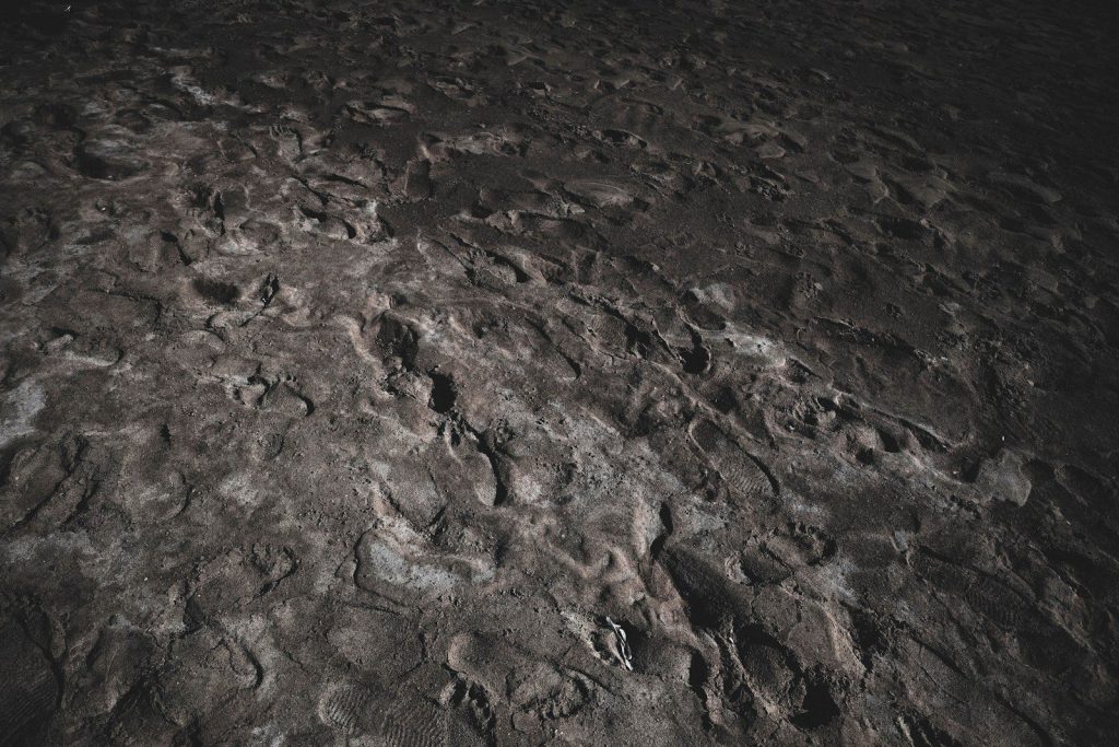 brown sand with water during daytime