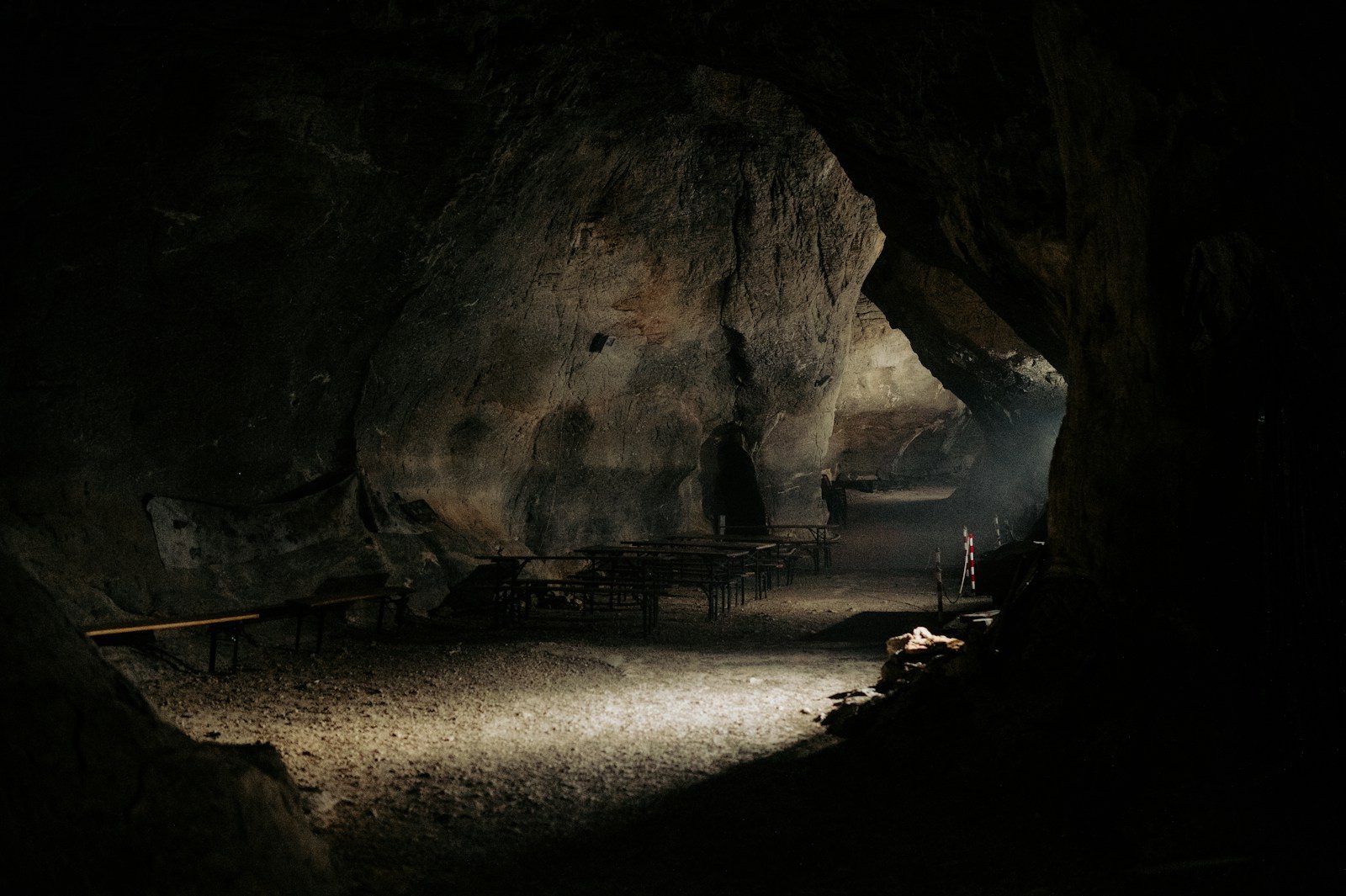 A dark cave with a person standing in it