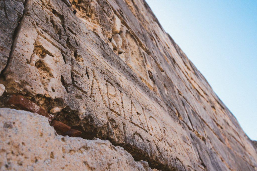 a close up of a stone wall with writing on it