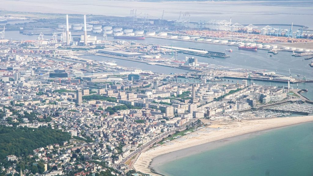 Aerial view of a coastal city with a large harbor.