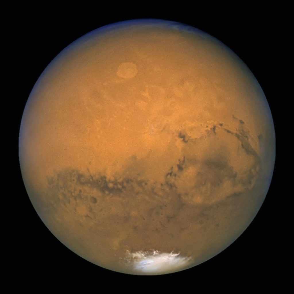 a very large orange planet with a black background