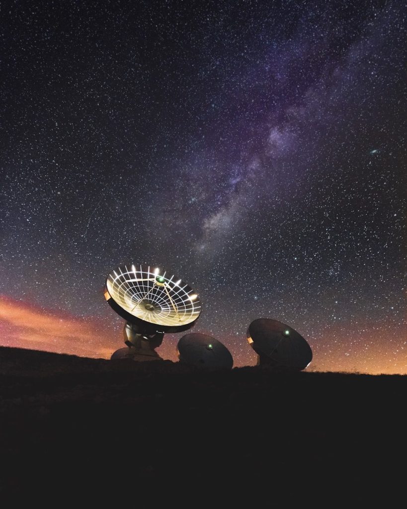 Radio telescopes under a starry night sky