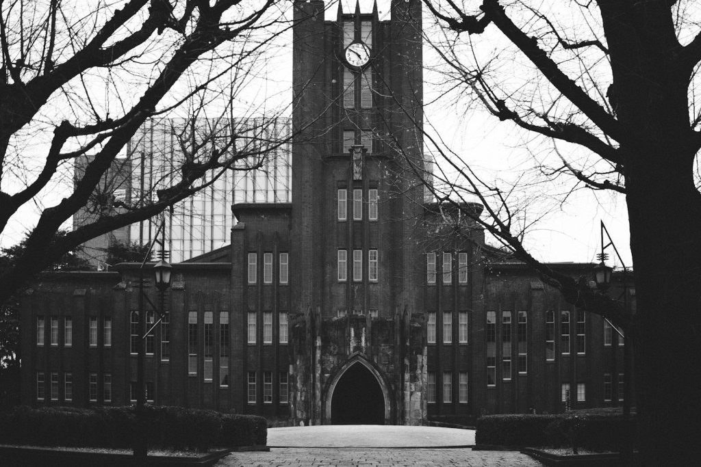 A black and white photo of a building with a clock tower