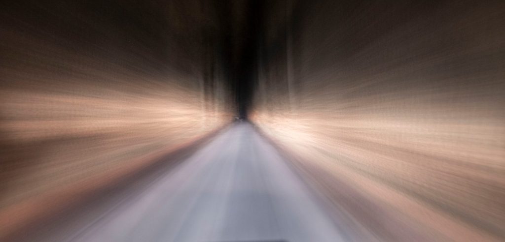 Speeding down a dark tunnel with light streaks