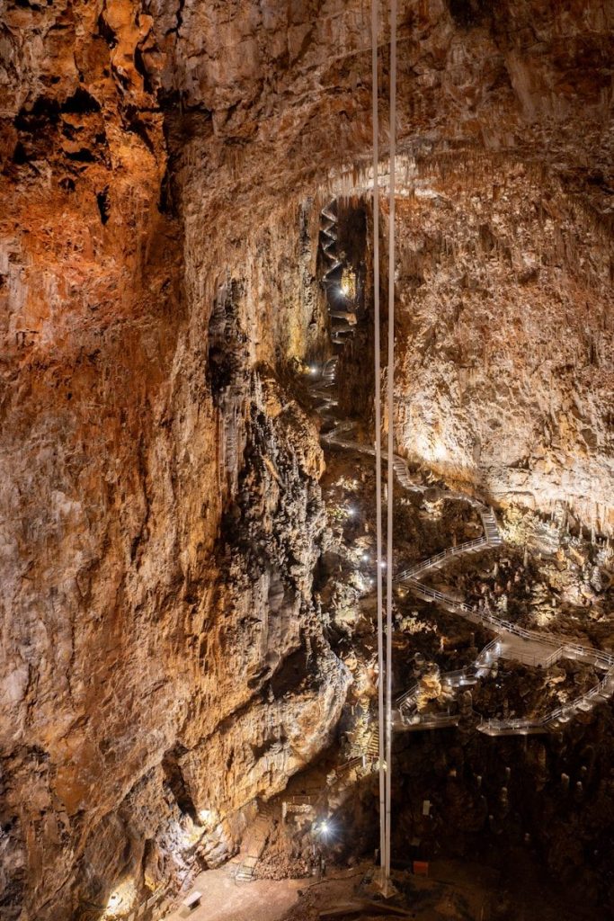 A man standing in the middle of a cave