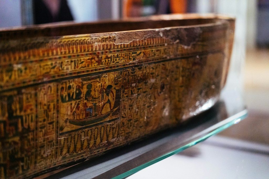Ancient egyptian sarcophagus with hieroglyphs on display