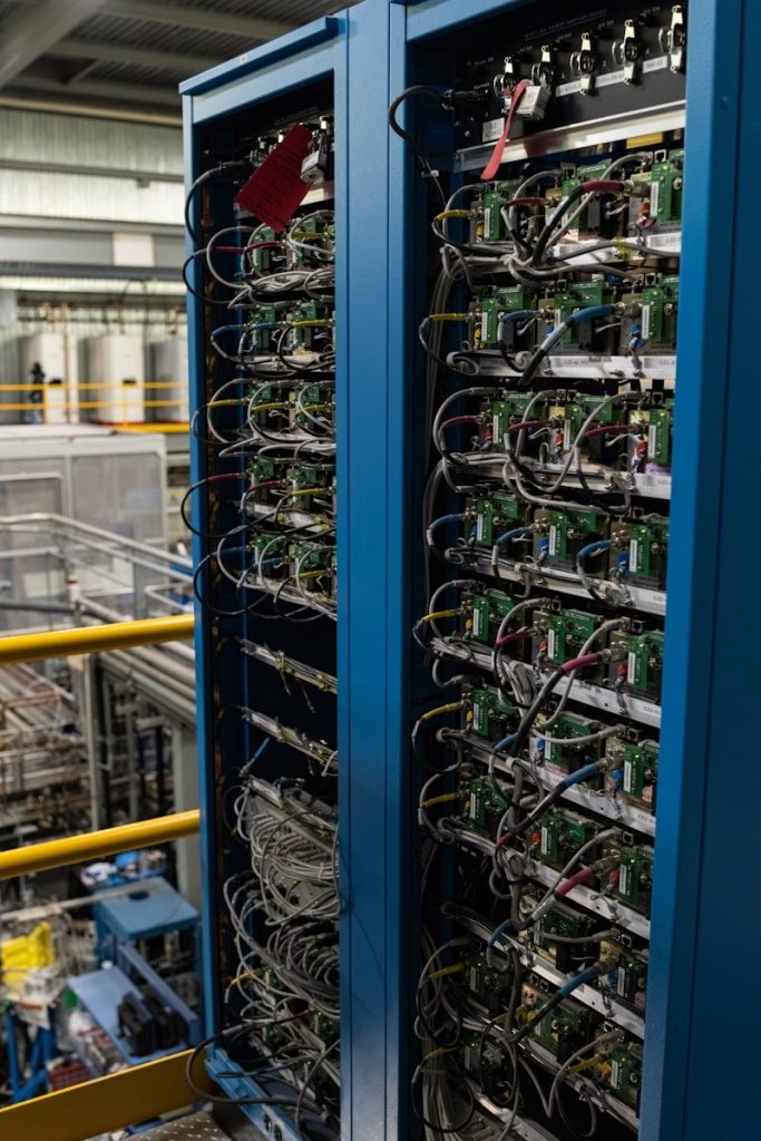 Two server racks filled with electronic components and wires