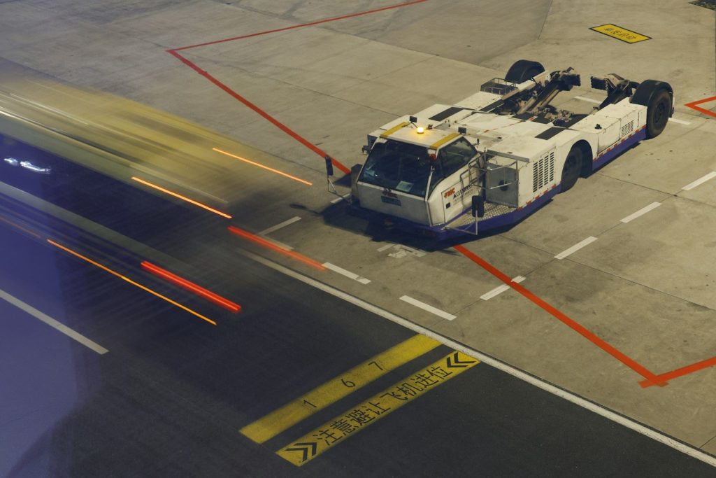 Aircraft tug on tarmac with light streaks