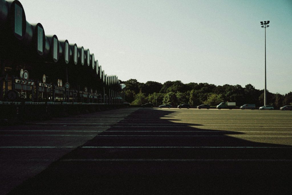 gray concrete road with trees on the side