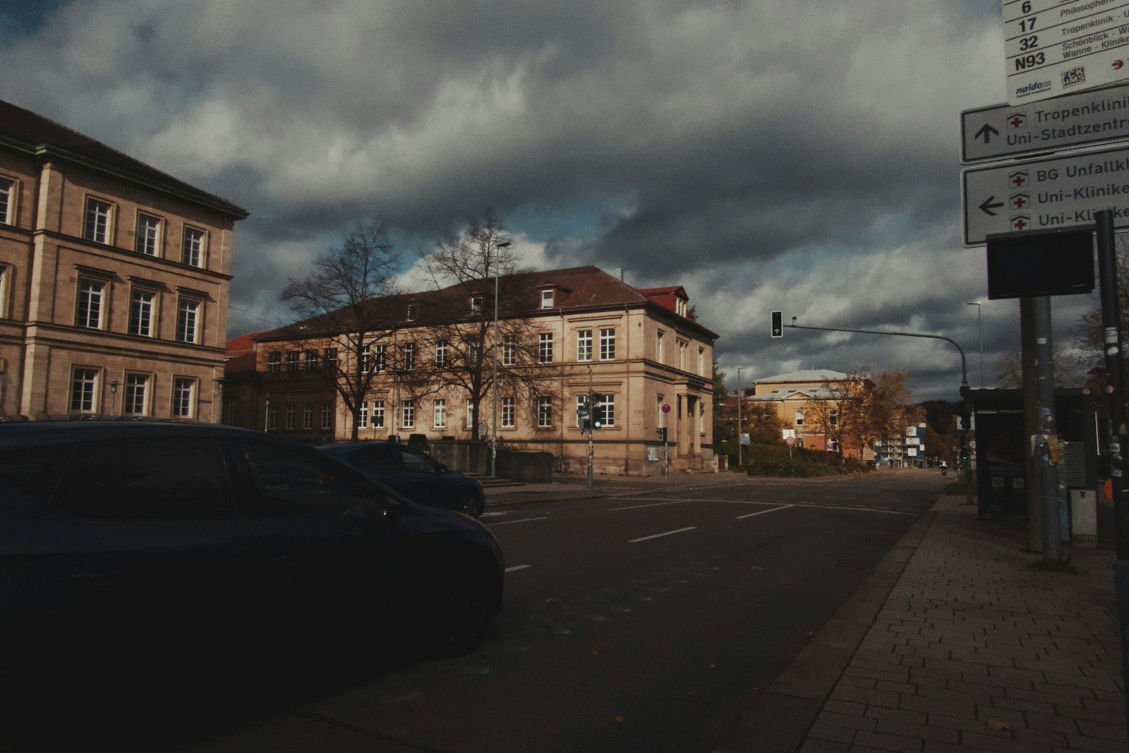 Cars on a street in front of buildings.