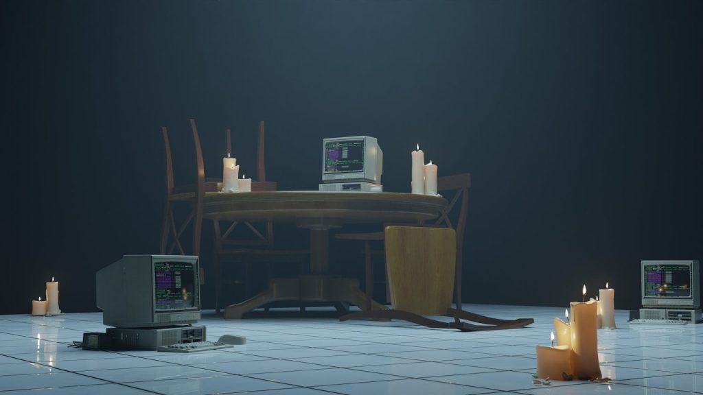 Candles surround old computers in the dark room.