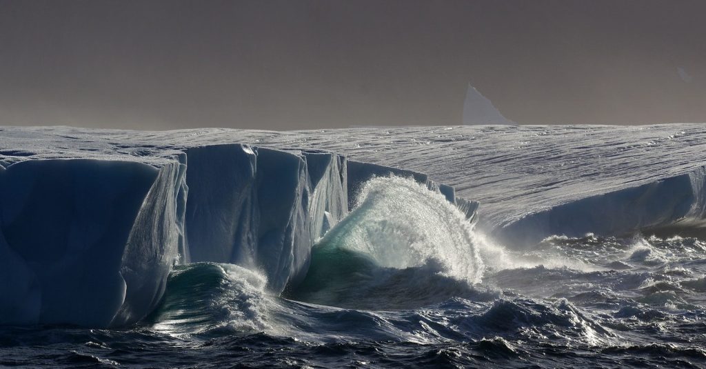 a large iceberg in the middle of the ocean
