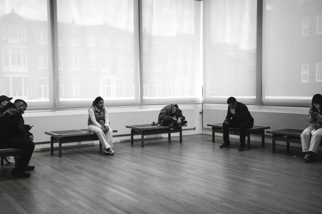 People sitting on benches in a room