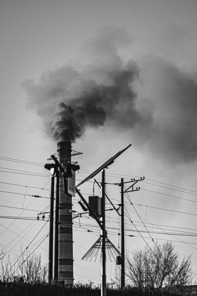 a black and white photo of a smoke stack