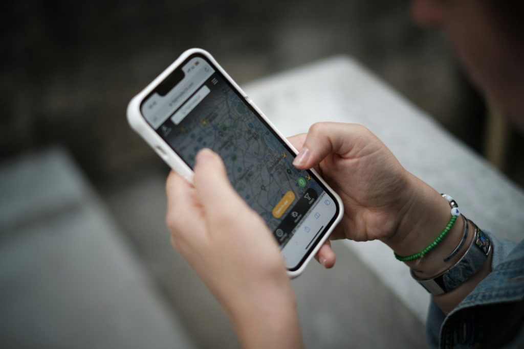 A person holding a smart phone in their hand