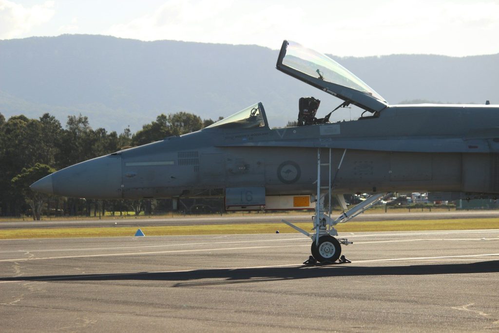A fighter jet sitting on top of an airport tarmac