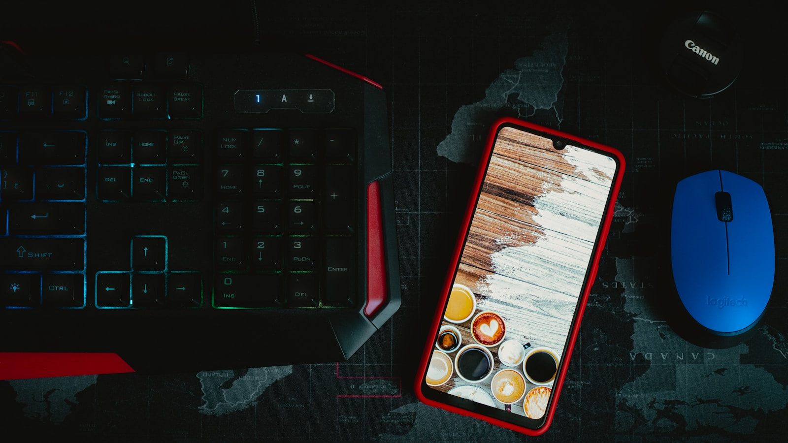 a cell phone sitting on top of a desk next to a keyboard