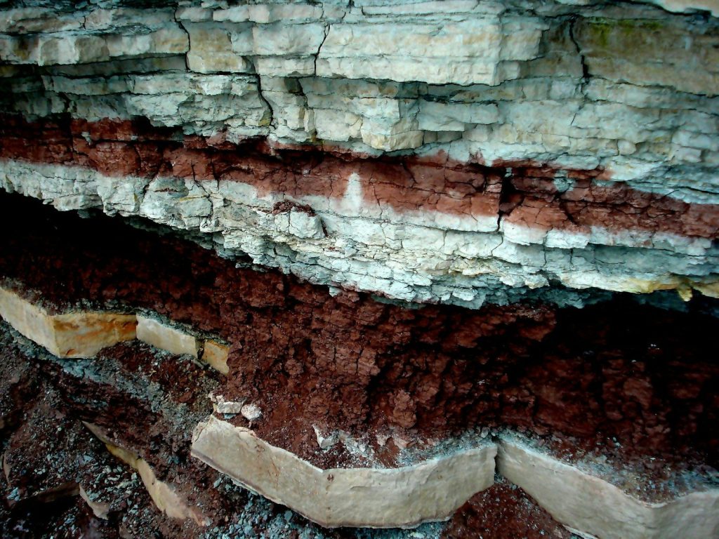 A close up of a rock formation with dirt on it
