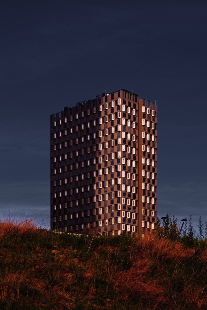 Modern building with checkered facade against dark sky