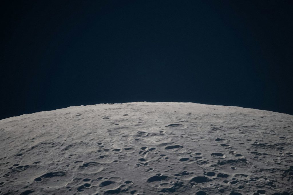 Cratered lunar surface against a dark sky