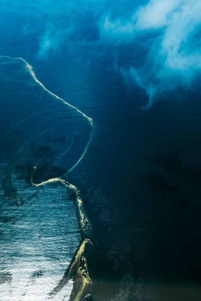 A large body of water surrounded by clouds