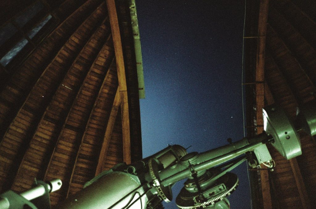a telescope mounted to the side of a building