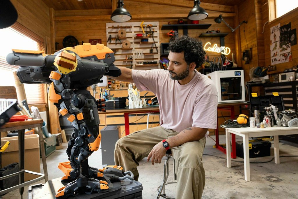 Man working on a large 3D printed sculpture.
