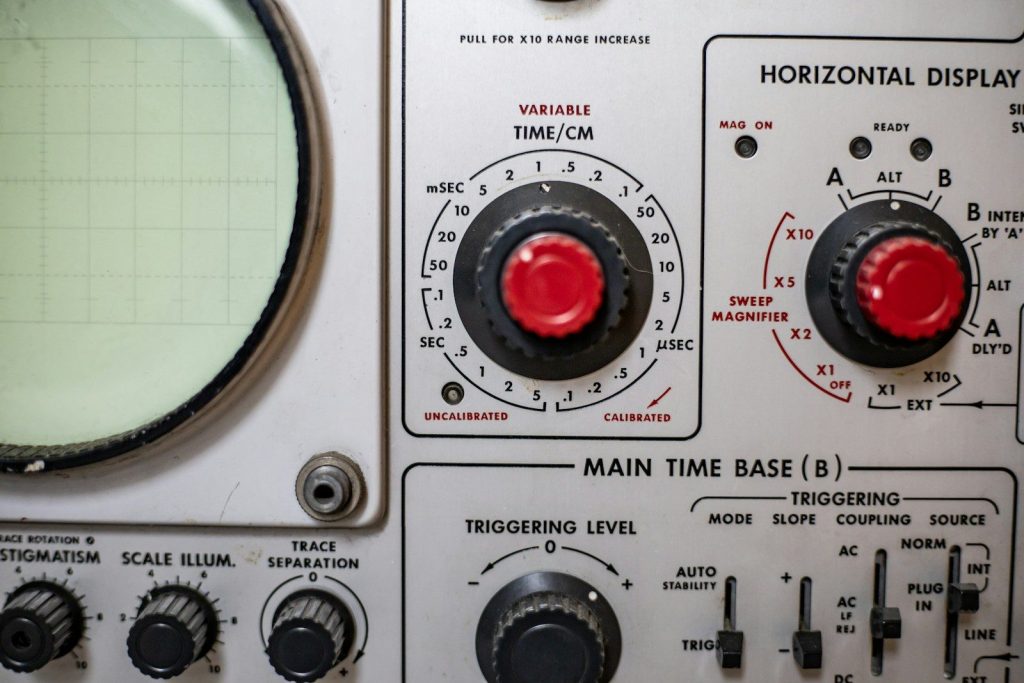 a close up of a machine with red knobs