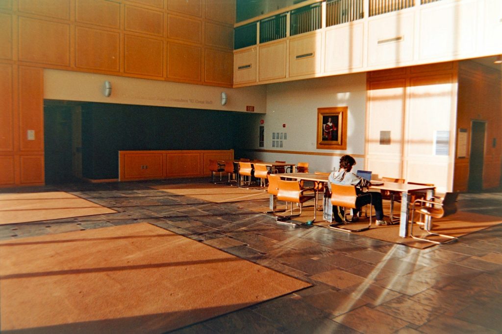 Man sitting at table in empty atrium