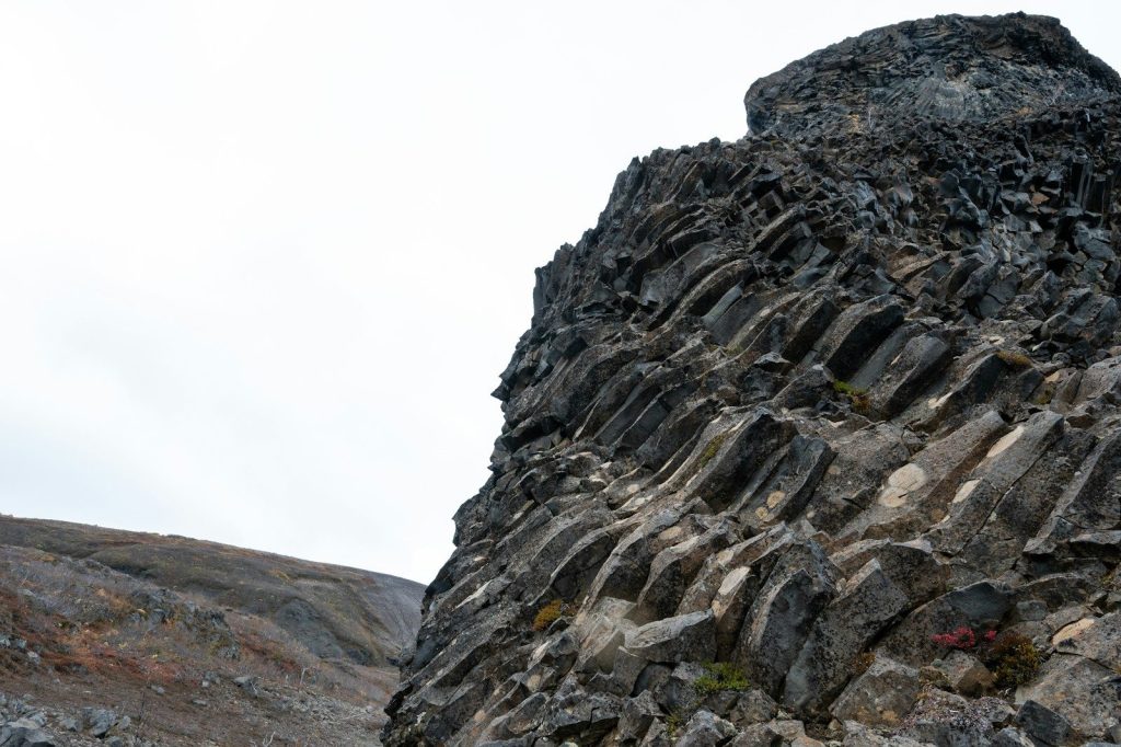 Columnar basalt formation stands tall against the sky.