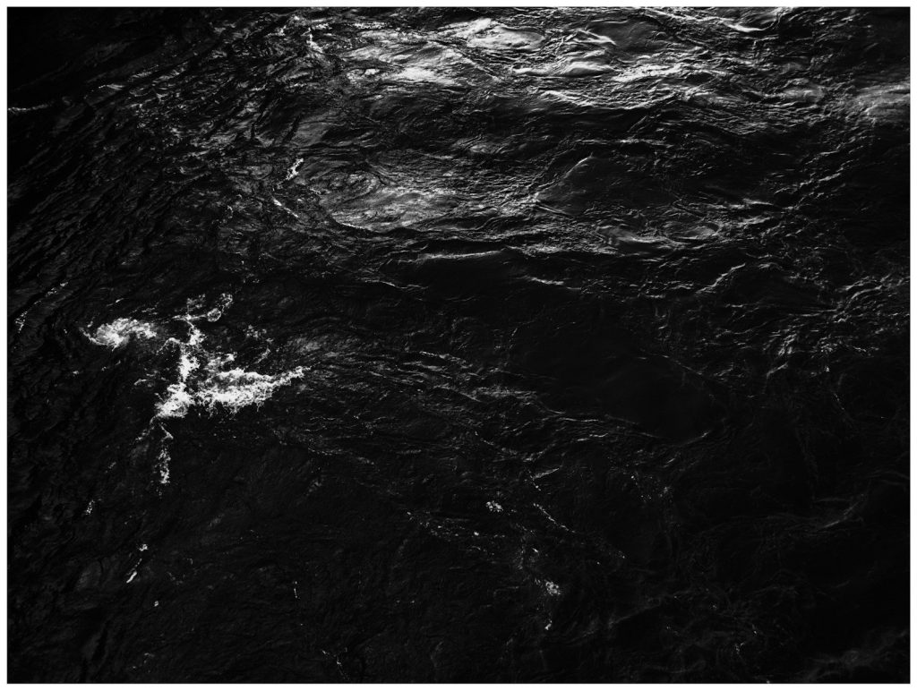 Rough dark texture with light ripples and streaks
