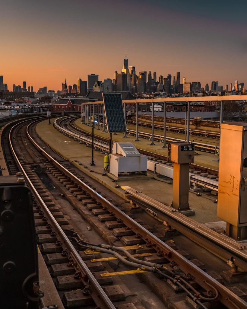 a train station with a city in the background