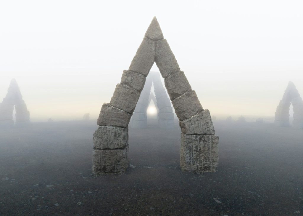 Arches emerge from the foggy landscape.