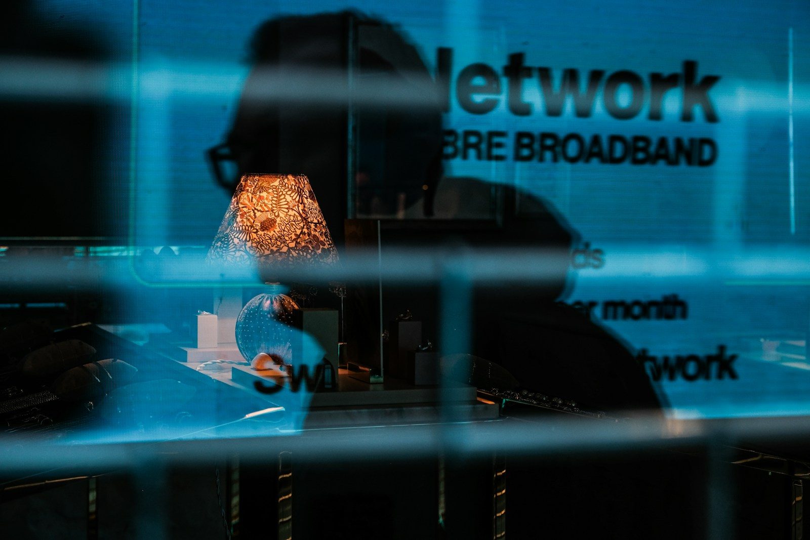 a reflection of a lamp in a glass window