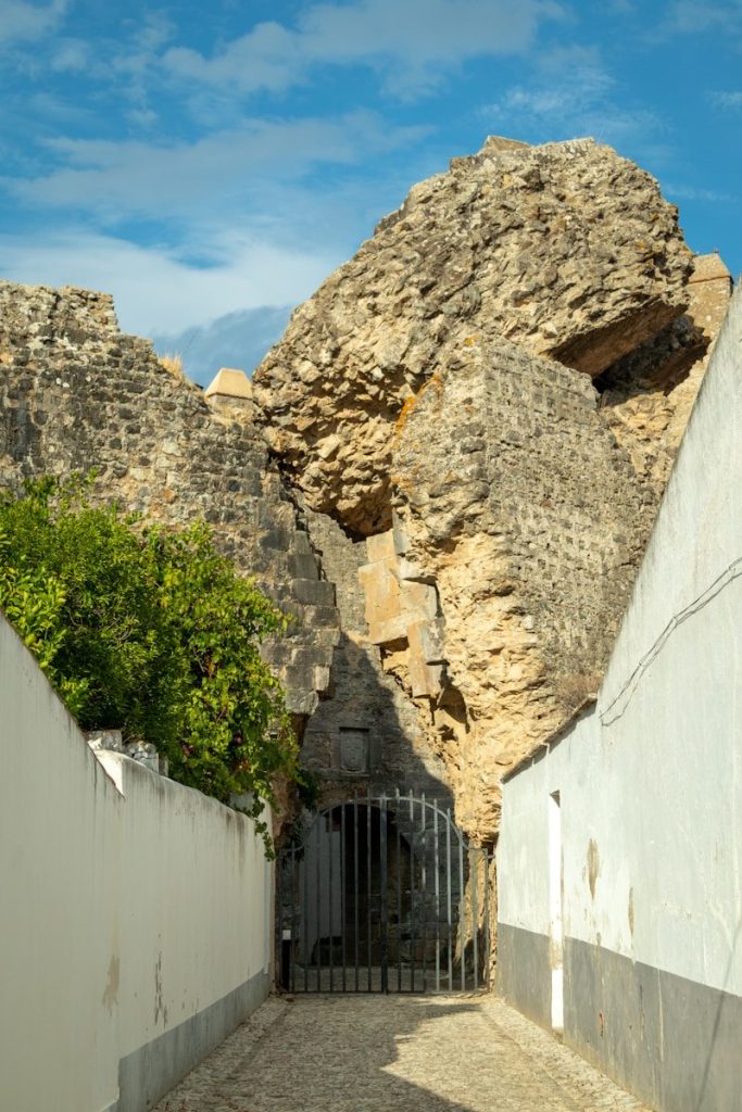 a stone building with a gate in front of it