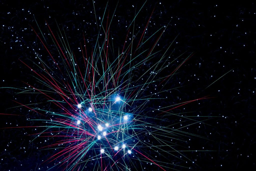 A colorful fireworks is lit up in the night sky