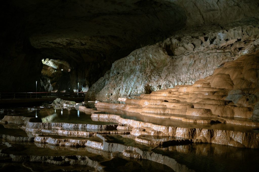 a cave with a pool of water inside of it