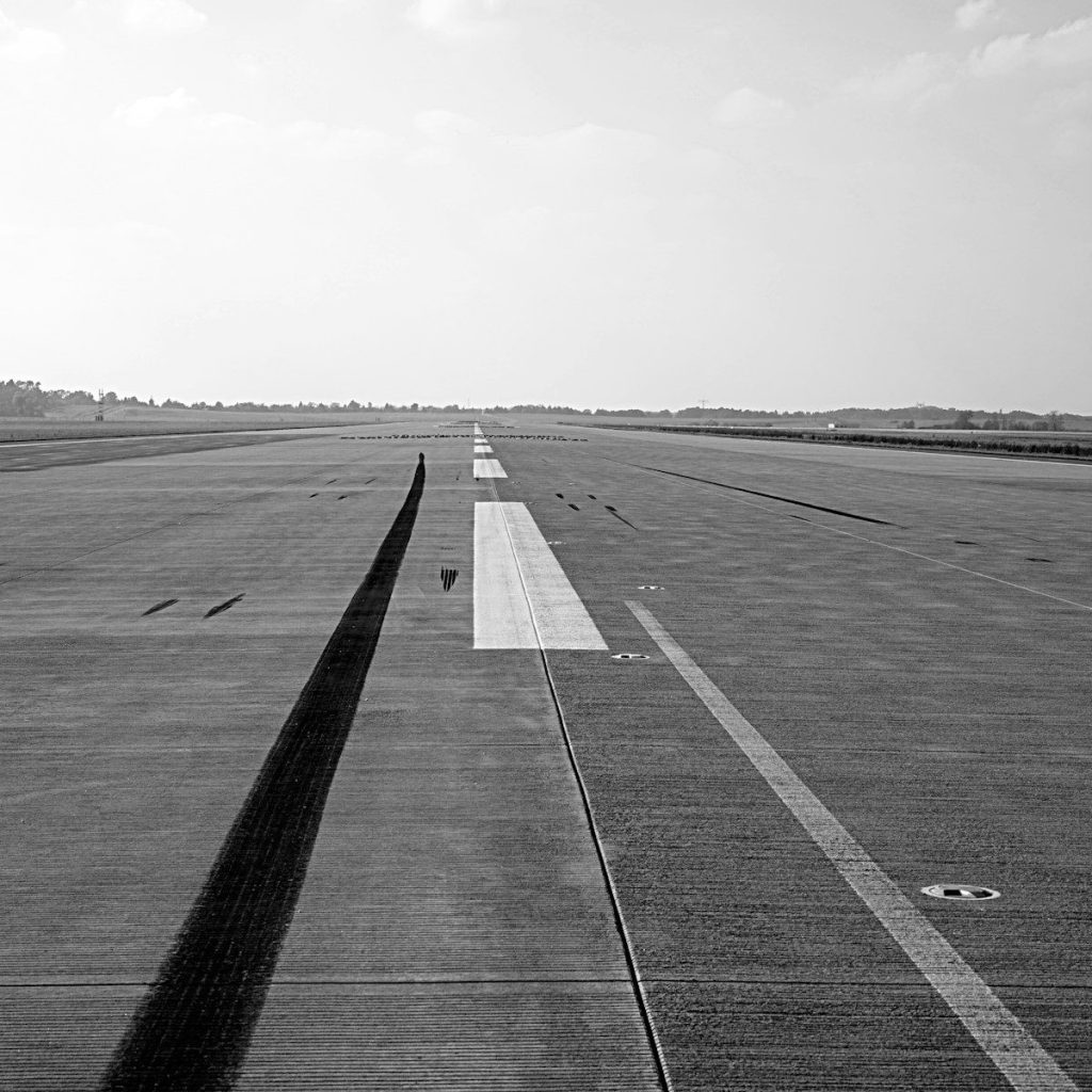 An empty airport runway stretching into the distance.