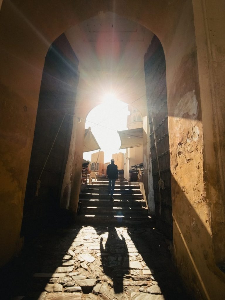 A person walking down a narrow alley way