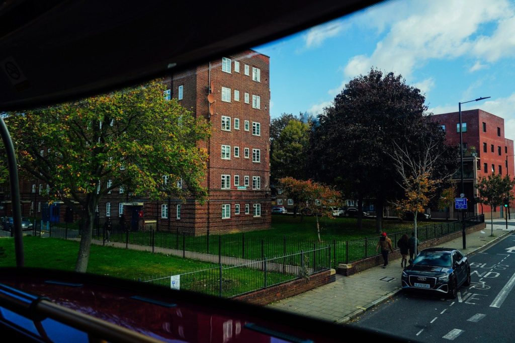Apartment buildings with trees and a street view.