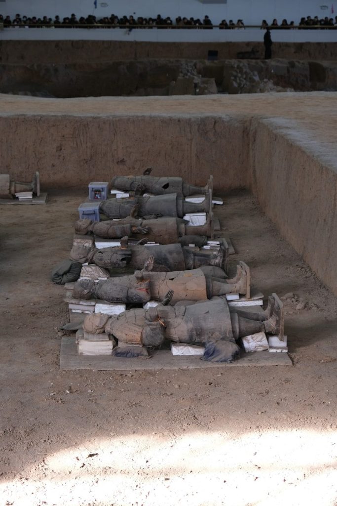 Terracotta warriors lie in excavation pit