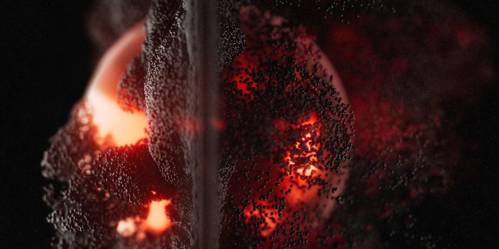 Glowing red orbs with dark textured surfaces.