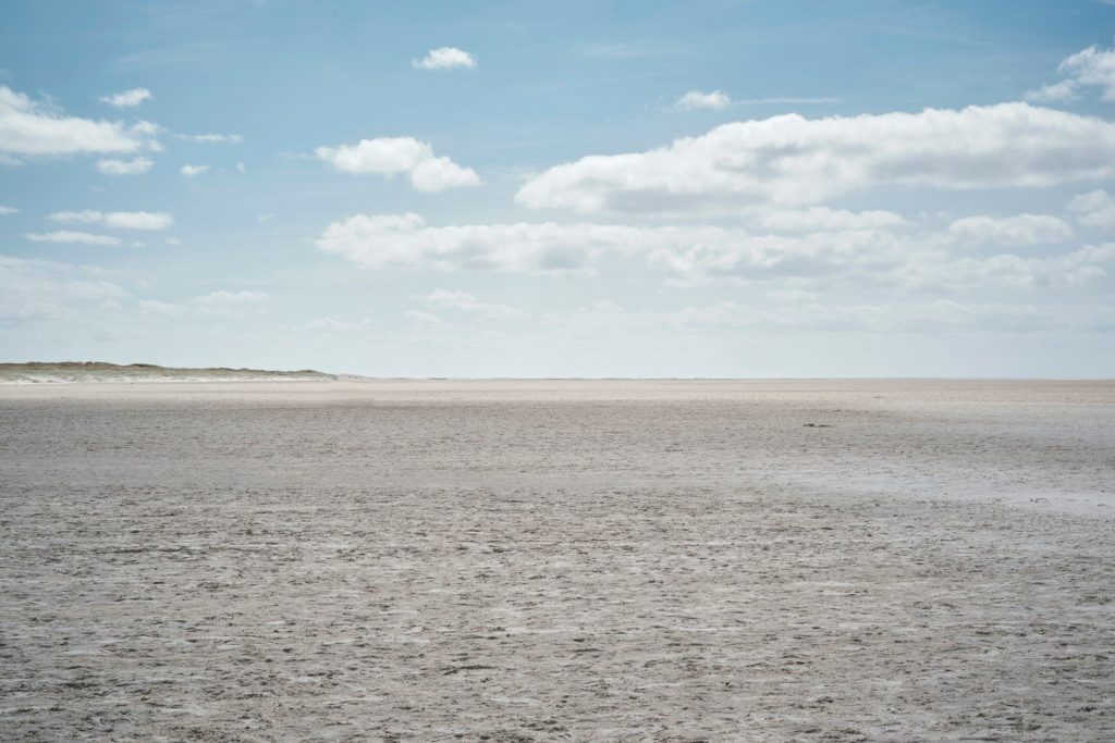 a large flat area with clouds in the sky