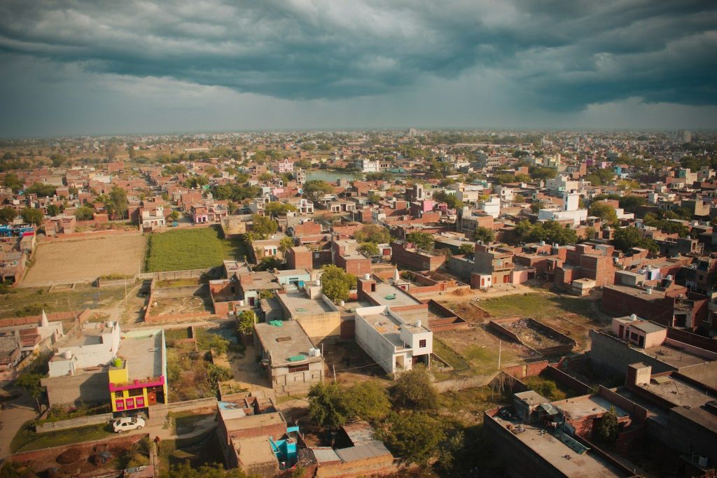 an aerial view of a city with a cloudy sky