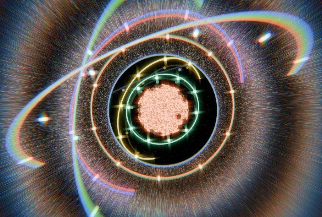Abstract atom model with orbiting rings and energetic background.