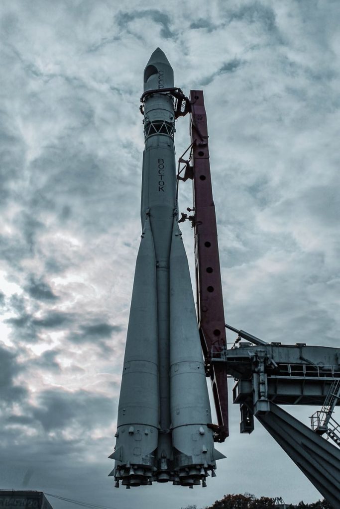 A towering rocket prepared for launch against a dramatic cloudy sky, showcasing advanced aerospace technology.