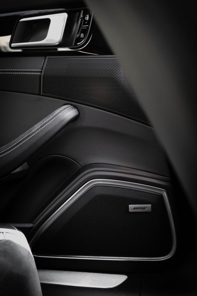 Detailed view of a modern car speaker system integrated into a door panel.